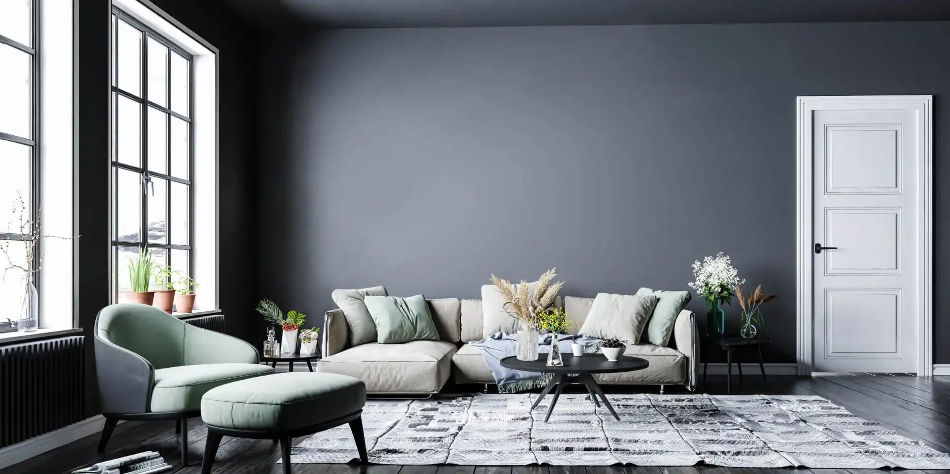Modernes Wohnzimmer mit dunkelgrauen Wänden, beigem Sofa, grünem Sessel und großen Fenstern